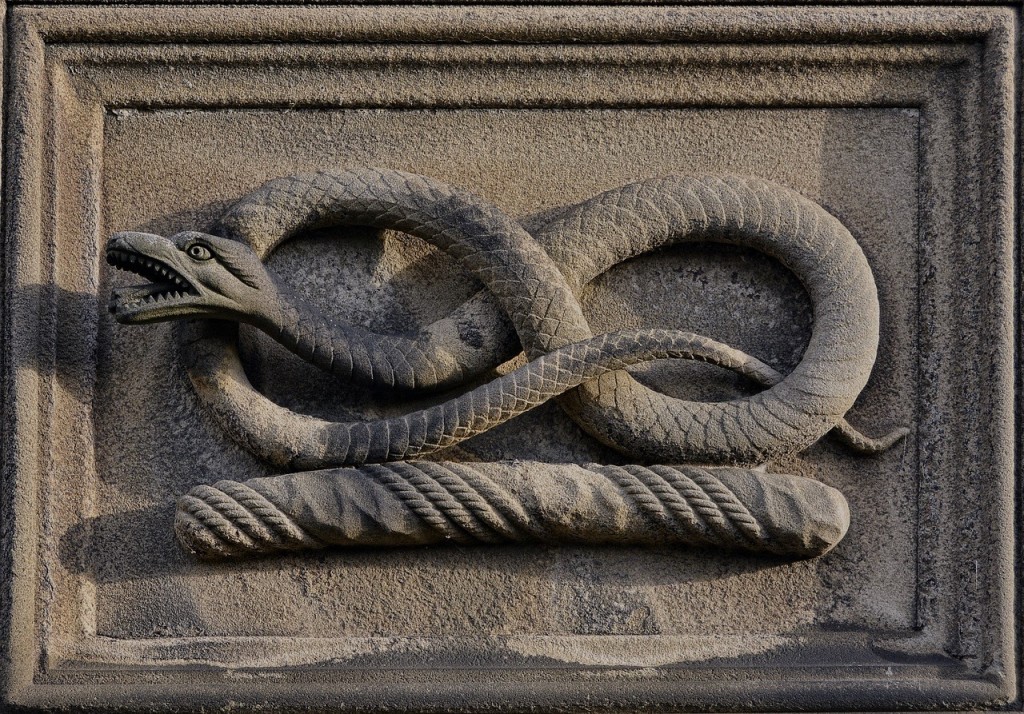 A stone snake coiled in the shape of an infinity symbol