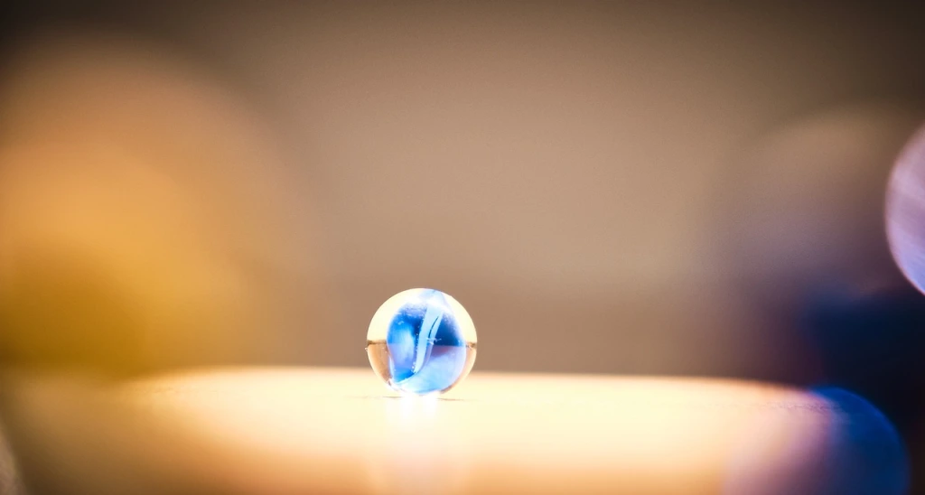 A blue marble in an aura of light.